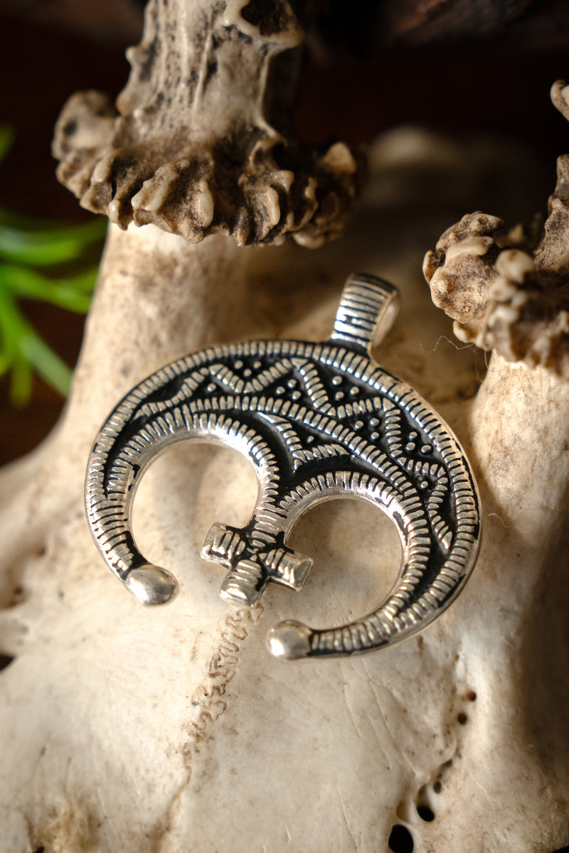 Lunula amulet with cross, silvered bronze