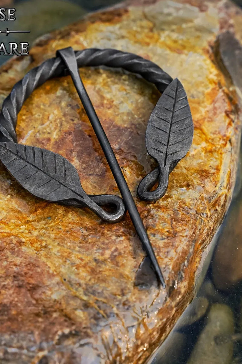 Twisted horseshoe fibula with leaf motif, iron