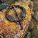 Twisted horseshoe fibula with leaf motif, iron
