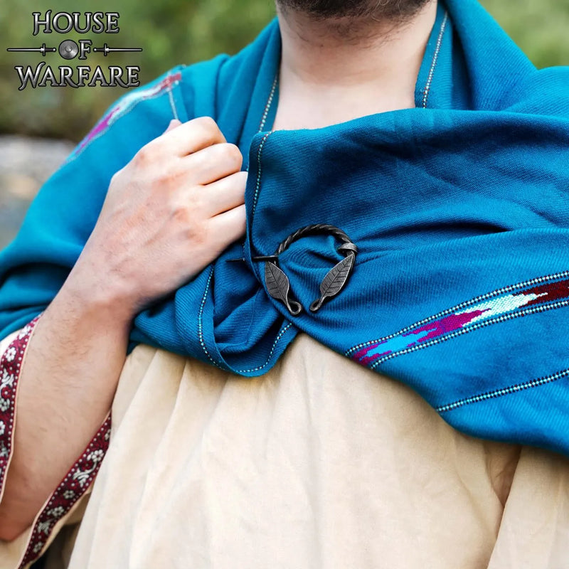 Twisted horseshoe fibula with leaf motif, iron