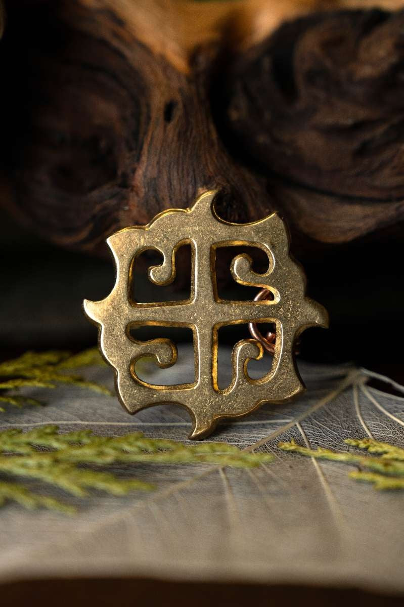 Roman disc fibula sun cross, bronze