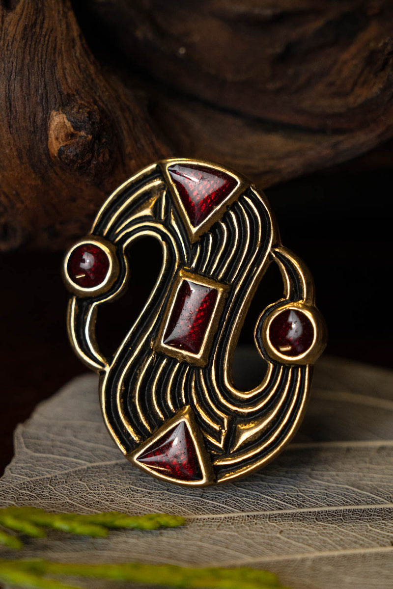 Merovingia S-fibula, bronce 